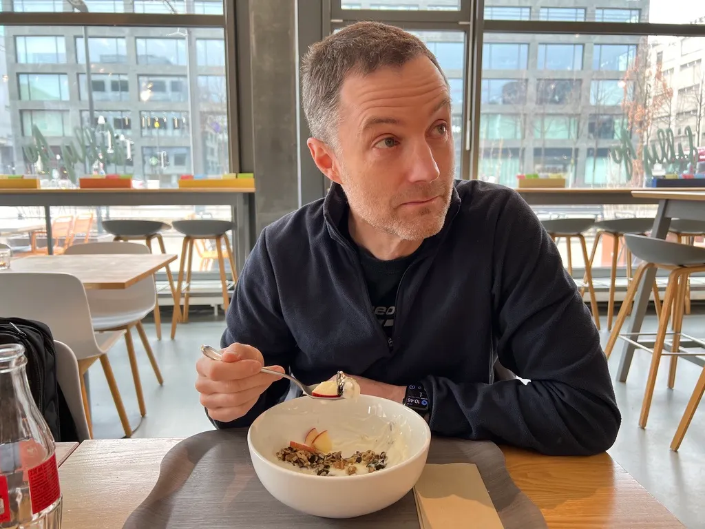 This is me sitting at a table in Switzerland. Photo by author’s wife, who is fabulous